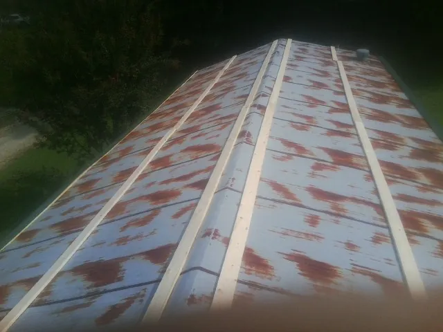 Rusted metal roof panels with new wood purlins before replacement — Storm Damage Roof Repair in Wray by Roofing Brothers